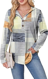 Detail of V-neck hoodie with decorative buttons and geometric color block patchwork pattern