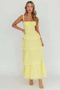 Detail of lemon yellow tiered chiffon dress featuring pleated bodice and spaghetti straps