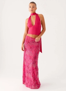 Close-up of pink skirt featuring intricate floral embroidery and silver sequins detail