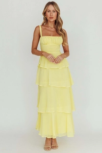 Detailed view of layered tiers and fine pleats on light yellow tiered maxi dress