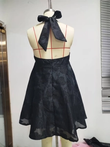 Detail of black backless halter dress with 3D rose jacquard fabric and neck bow tie