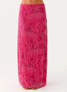 Detail of fuchsia sequins tassels and 3D floral embroidery on slim-fit midi skirt