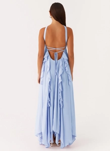 Close-up of backless light blue dress featuring ruffled edges and cross lace-up ties