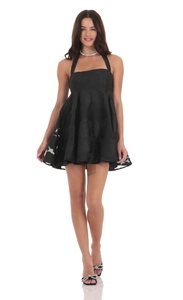 Detailed view of the black halter mini dress with embossed floral jacquard patterns