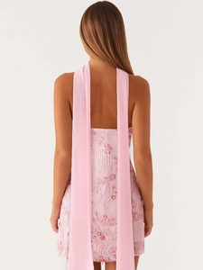 Sleeveless pink sequin mini dress with floral embroidery and open back streamers
