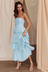 Dettaglio dell'abito a fascia azzurro con balze a strati e texture plissettata elegante