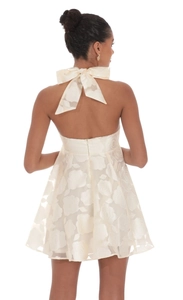 Detail of rose texture jacquard fabric and back bow tie on ivory backless cocktail dress