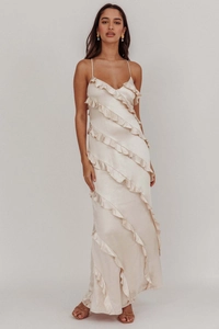 Detail of elegant champagne pink satin maxi dress with tiered ruffle layers and thin straps