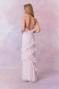 Close-up of pink floral chiffon dress featuring multi-layered ruffled hem and backless design