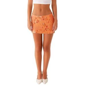 Detailaufnahme des orangen Minirocks mit 3D-Blumenperlen und Paillettenstickerei