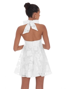Elegant white backless mini dress with large bow tie and floral jacquard pattern for parties
