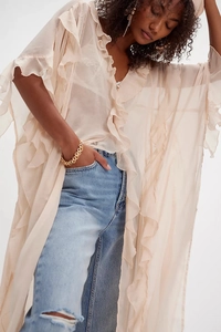 Detail of sheer apricot chiffon kimono with ruffled edges and lightweight texture