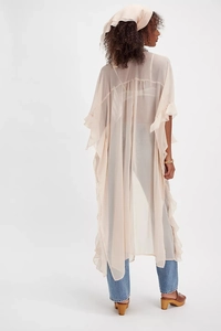 Detail view of the light apricot sheer chiffon cardigan with ruffled edges for resort wear