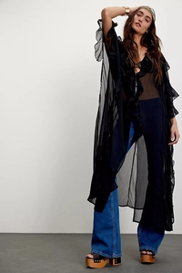 Detail of bohemian black sheer cardigan featuring layered ruffle edges and flowy mesh texture