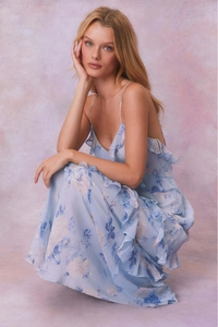 Detailed view of ruffles on light blue floral chiffon dress for beach vacation