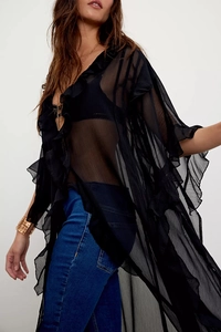 Detailed view of black sheer mesh layers and ruffled edges on this bohemian-style cardigan