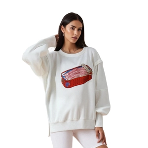Detail of white round neck sweatshirt featuring a vibrant sardine can print and side slits