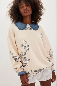 Detail of retro cream sweater with contrast denim Peter Pan collar and floral prints