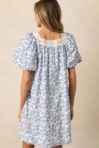 Detail of floral puff sleeve dress showing lace square neckline and blue flower pattern