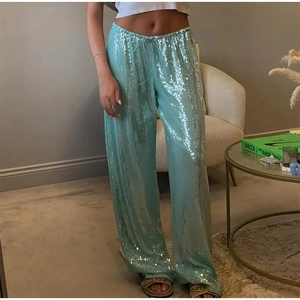 Détail du pantalon large à paillettes bleu clair avec cordon de serrage et texture brillante