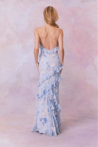 Detail of light blue floral chiffon dress with low back and layered ruffle hemline