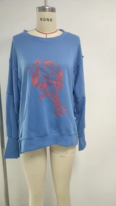 Detail of blue long-sleeve sweatshirt with a large red lobster graphic and ribbed cuffs