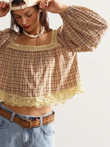Detail of bohemian plaid top featuring intricate lace trim on the square neckline and hem