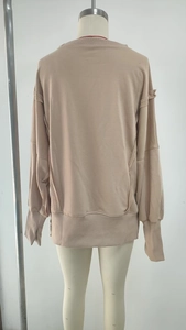 Back view of apricot crewneck sweatshirt featuring stylish outer seam stitching detail
