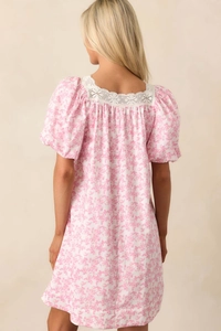Detail of square neckline with lace trim and puff sleeves on floral summer dress