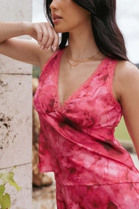 Detailed view of pink marble print satin top with delicate lace trim on the V-neckline