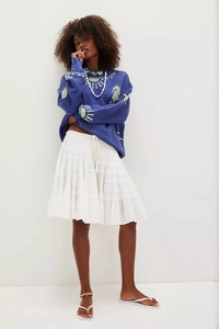 Detail of navy sweatshirt with yellow seahorse print and white layered ruffle skirt