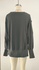 Detailed back view of a dark grey loose sweatshirt with ribbed cuffs and drop shoulder