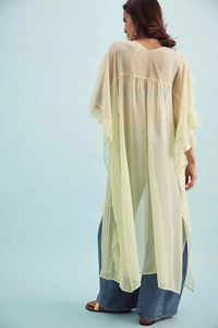 Detailed view of light yellow sheer maxi cardigan with ruffled cuffs and textured fabric