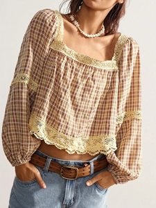 Detail of bohemian plaid shirt with vintage beige lace trim and hollow embroidery