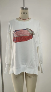 Close-up of red sardine tin print on white crewneck sweatshirt with ribbed cuffs