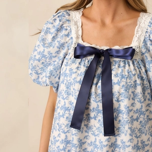 Floral puff sleeve dress with lace square neck and a navy blue satin bow detail