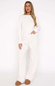Detail of white waffle knit pajama set featuring delicate pink bow pattern