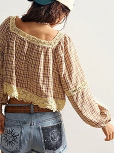 Detail of plaid shirt with lace trim and sun moon graphic on denim shorts pocket
