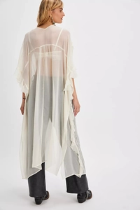 Detail of sheer off-white ruffles on a long flowy summer cover-up for women