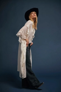 Detailed view of white chiffon cover-up featuring ruffled bohemian style sleeves and hem