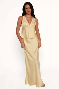 Close-up of light yellow satin camisole top with lace trim and matching maxi skirt