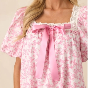 Pink floral summer dress with lace square neck, puff sleeves and large satin bow detail