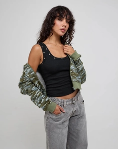 Detail of black ribbed tank top with eyelets and camouflage hooded zip-up jacket