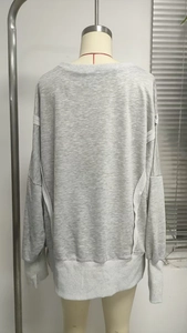 Rear view of loose grey long-sleeve sweatshirt with back seam detail on mannequin
