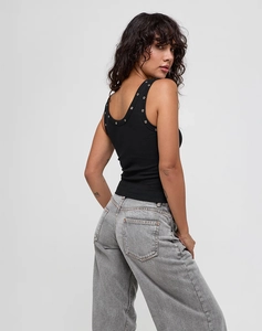 Detail shot of the black ribbed tank top showing metallic grommet edges and textured fabric