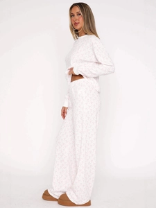 Women's white waffle knit pajama set featuring pink bow prints and elastic high waist pants