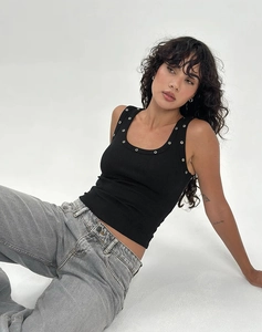 Close-up of black ribbed tank top with silver metal grommets on neckline and straps