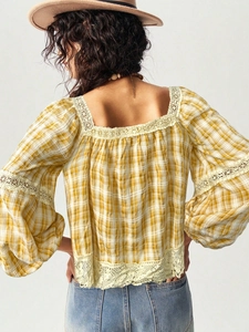 Back view of yellow plaid lace blouse featuring lantern sleeves and floral trimmings