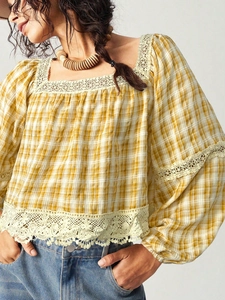 Close-up of yellow plaid blouse with white lace trim and square neck bohemian detail