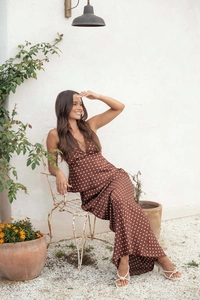 Detailed view of brown polka dot satin maxi dress with lace trim and elegant V-neckline